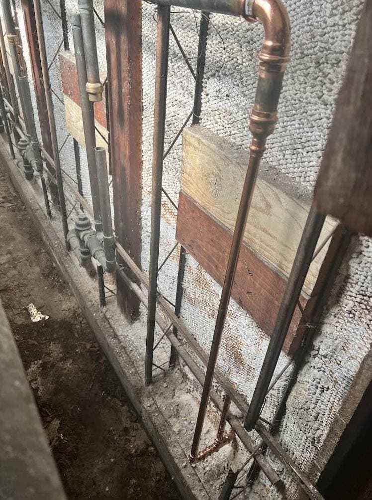 Crawlspace Plumbing Risers Along the Foundation Wall